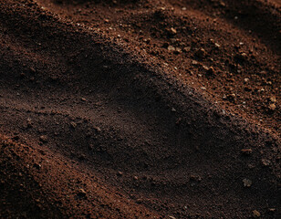 Rich, dark soil ready for planting seeds, a fertile ground texture perfect for agriculture, gardening, and environmental projects needing natural earth elements