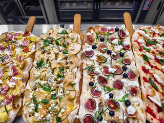 Delicious variety of gourmet pizzas served in a restaurant during a lively evening