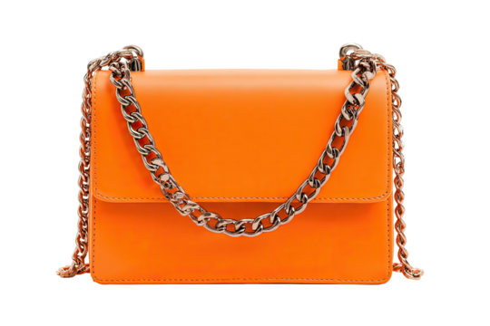 Bright orange shoulder bag with silver chain strap against a transparent backdrop