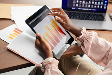 Woman analyzing business data using digital tablet