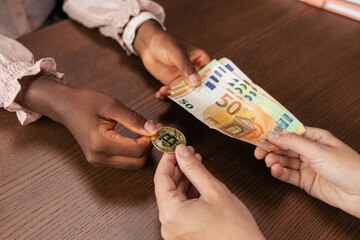 People exchanging bitcoin for euro currency, financial transaction