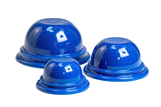 Three glossy, blue, rounded, bowl-like objects of varying sizes arranged together on a dark background