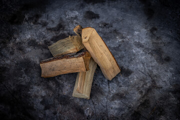 A Close-Up View of Stacked Firewood on a Dark Background: Perfect for Campfires, Cozy Evenings, and Outdoor Gatherings