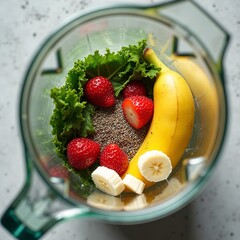 A close up of a colorful assortment of fresh smoothie ingredients berries kale banana and chia seeds in a blender jar