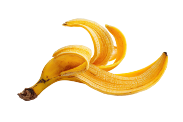 A vibrant yellow banana peel against a stark black background, showcasing its peeled form
