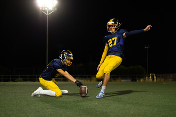 American football players attempting field goal at night © luisrojasstock