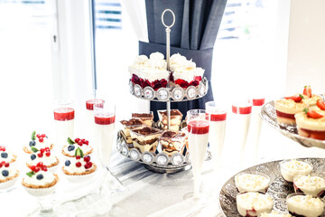 Dessert buffet or candy bar during catering event, fruits and whipped cream