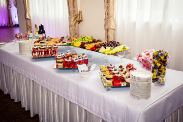 Dessert buffet or candy bar during catering event, fruits and whipped cream