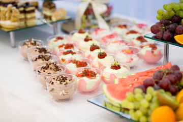 Dessert buffet or candy bar during catering event, fruits and whipped cream