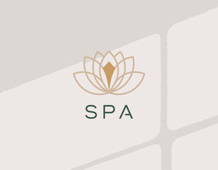 This elegant logo features a beautifully designed lotus flower, symbolizing tranquility and wellness associated with spa services and holistic healing experiences.