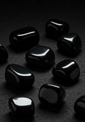 Black Polished Stones on Dark Textured Background