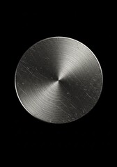 Metallic Circular Disc with Textured Surface on Black Background