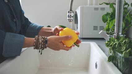 Woman Washing Yellow Pepper
