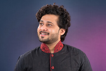 Fototapeta premium Portrait of a happy young Indian traditional man posing