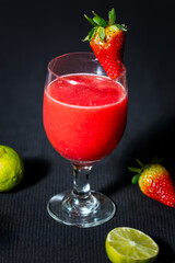 Glass of Watermelon Juice with lemon on dark background.
