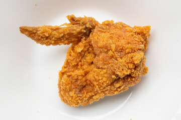 crispy fried chicken on white plate close up