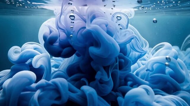 Watch abstract blue ink gracefully swirl and diffuse underwater in a mesmerizing dance of color and fluid motion, perfect for backgrounds