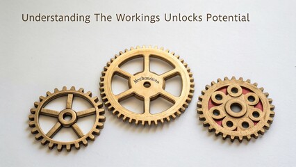 Close up of three golden gears demonstrating industrial mechanics