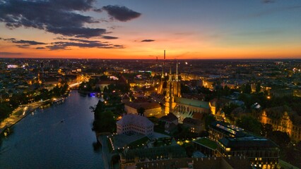 Evening Panorama of Wrocław – Aerial View of Ostrów Tumski with Illuminated Street Lamps