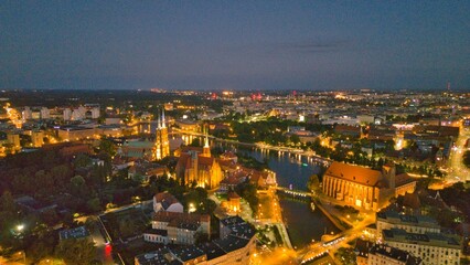Evening Panorama of Wrocław – Aerial View of Ostrów Tumski with Illuminated Street Lamps