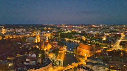 Evening Panorama of Wrocław – Aerial View of Ostrów Tumski with Illuminated Street Lamps
