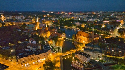 Evening Panorama of Wrocław – Aerial View of Ostrów Tumski with Illuminated Street Lamps