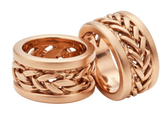 Two rose gold wedding rings with braided design isolated on white, elegant jewelry for marriage and engagement celebration