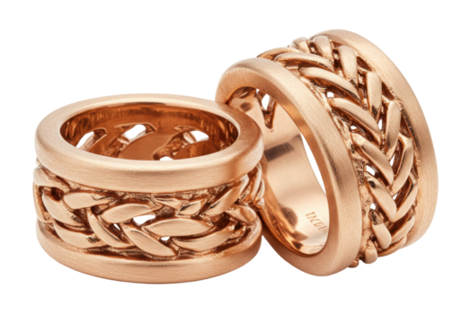 Two rose gold wedding rings with braided design isolated on white, elegant jewelry for marriage and engagement celebration