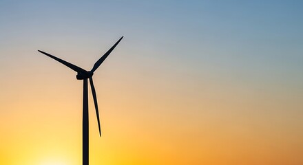 Fototapeta premium Silhouette of a wind turbine against a gradient sky at sunset creating a renewable energy scene