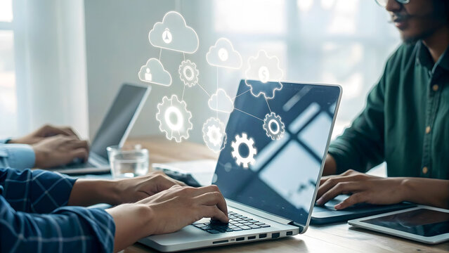 Team collaborating on cloud computing project, using laptops and tablets to access data and applications for seamless integration and efficient workflow - Powered by Adobe