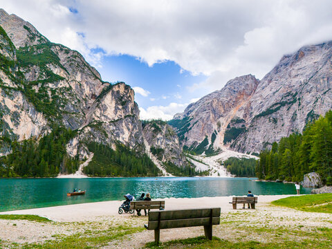 Lago di Braies or Lake Braies crystal blue lake with wooden rowing boats in Italian Dolomites. Mountain forest lake in Italian apls Dolomites South Tyrol. Mountain summit ridge. Glacier lake. 