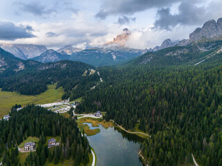 Aerial view of breathtaking landscape of Lake Misurina and hotel. Dolomites mountain in background, IAlpine lake in the Italian Alps. Drone view of Lago di Misurina. Mountain forest lake with a view.
