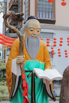  Sage elder philosopher holding book and staff, Confucius statue in Buddhist temple. Concept of wisdom, knowledge and ancient traditions , Kuala Lumpur, Malaysia, February 9, 2025