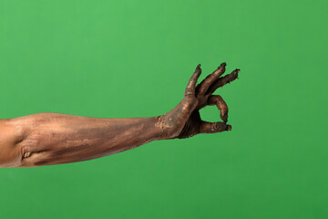 A creepy zombie hand gives the OK sign