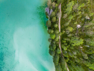 Aerial view of breathtaking landscape of Lake Misurina and hotel. Dolomites mountain in background, IAlpine lake in the Italian Alps. Drone view of Lago di Misurina. Mountain forest lake with a view.