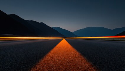 A long, dark road with blurred light trails extending from a bright centerline and mountains