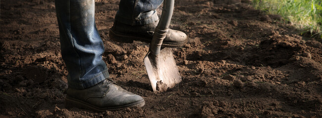 Man's feet with a shovel