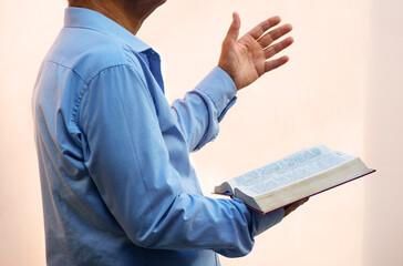 A man with a bible preaches