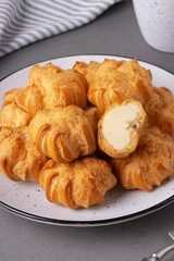 Cakes profiteroles arranged on a plate ready for enjoyment during a cozy afternoon