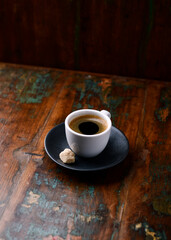 Cup of coffee on rustic wooden background. Soft focus. Copy space	