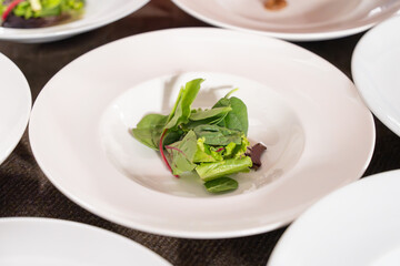 Fresh mixed green salad starter on white plate