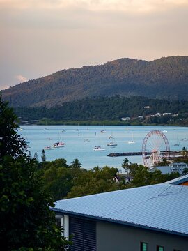 Sailboat on the water with city buildings in background, Whitsunday