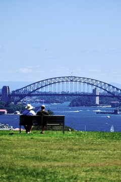 View of Sydney Harbour Bridge from a park bench