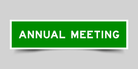 Green color square shape sticker label with word annual meeting on gray background
