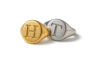 Gold and silver signet rings with H and T initials, isolated on transparent background