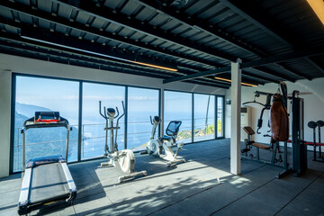 Modern Gym with Scenic View: A well-equipped fitness space with state-of-the-art exercise machines...