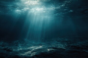 View from below the ocean's surface, sunlight penetrating deep blue water, casting rays