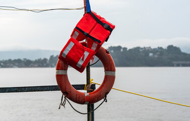 A lifebuoy and life jacket placed on a boat