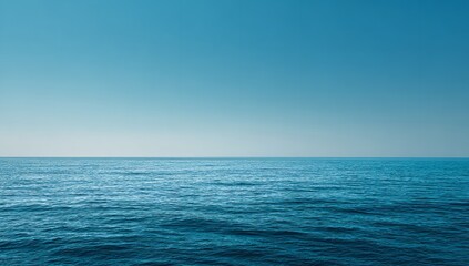 Obraz premium Serene ocean horizon under vast, clear blue sky evokes tranquility and boundless possibility for travel, nature, and wellness themes