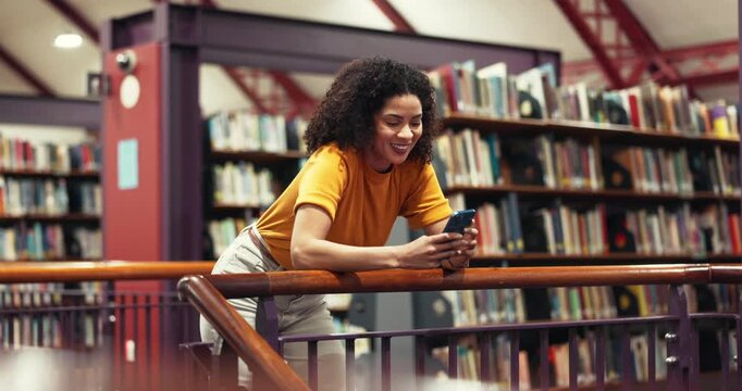 Happy woman, student and typing with phone in library for research, ebook or social media. Female person, bookstore and smile with mobile smartphone for knowledge, study or online app in book shop